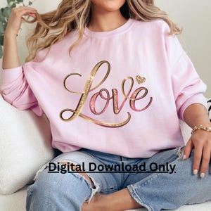 May include: A light pink sweatshirt with the word "Love" in gold glitter script and a small gold heart. The text "Digital Download Only" is printed at the bottom. The sweatshirt is a casual style.