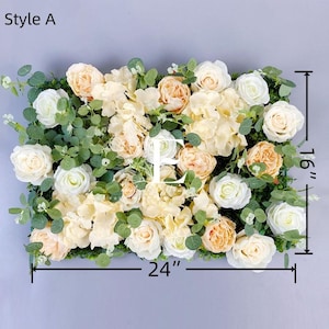 May include: Rectangular floral arrangement, Style A, featuring white, peach, and cream-colored roses and hydrangeas, with green foliage. The arrangement measures 24 inches wide and 16 inches high.