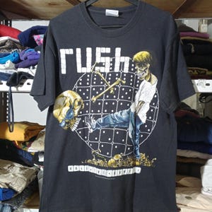 May include: A set of three ceramic canisters with lids. The canisters are white with a blue floral pattern. The largest canister is 8 inches tall, the medium is 6 inches, and the smallest is 4 inches.