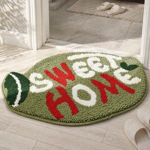 Puede incluir: Un letrero de madera rústica con la frase "Welcome to our home" en letras blancas. El letrero presenta un acabado envejecido y un diseño sencillo y acogedor, ideal para un porche o entrada.