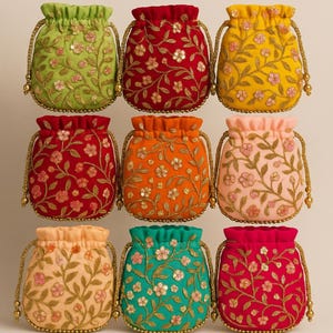 May include: Nine colorful drawstring pouches with floral embroidery. The pouches are in various colors, including green, red, yellow, orange, pink, peach, teal, and fuchsia. Each pouch has a gold-colored drawstring and floral design.