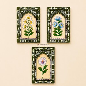 May include: Three rectangular wall art pieces featuring arched frames with dark green borders and white floral patterns. Each piece displays a single botanical illustration of flowers in yellow, blue, or light purple with green leaves on a cream background.