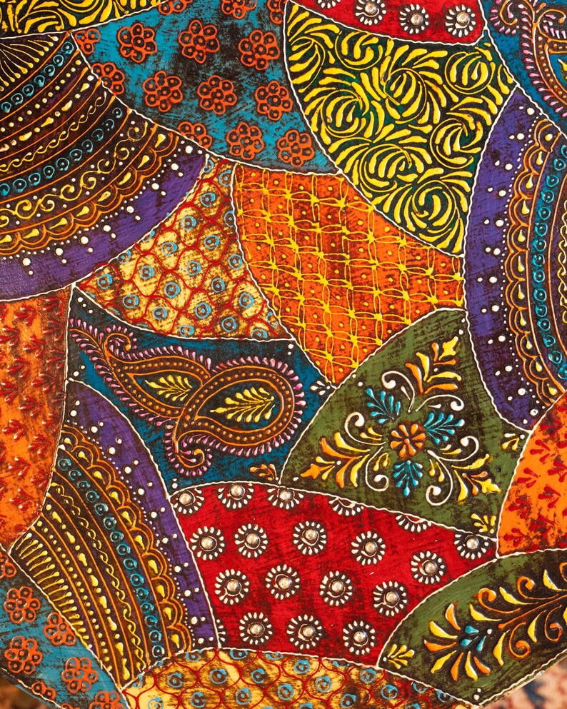 May include: A vibrant, patchwork design featuring a variety of colors and patterns. The image showcases a mix of paisley, floral, and geometric motifs in shades of red, orange, green, blue, and purple. The design is reminiscent of a textile or fabric.