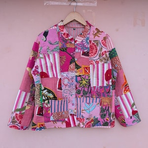 May include: A quilted jacket featuring a patchwork design with various pink, white, and multi-colored floral and animal patterns. The garment has long sleeves, a mandarin collar, and a front button closure, constructed from stitched fabric panels.