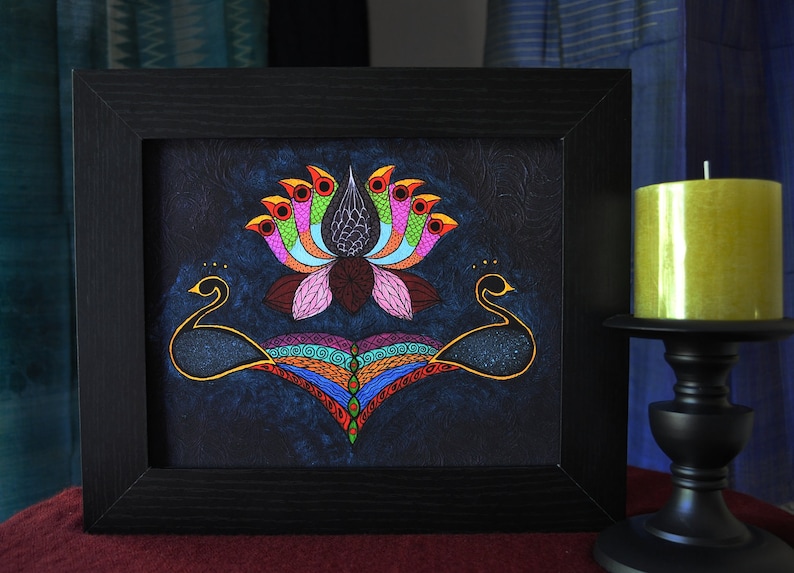 May include: A framed painting of a colorful lotus flower with two black peacocks on either side. The background is a dark blue with a starry effect.