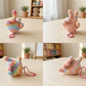 May include: Crocheted hand-shaped keyrings in various poses. One keyring is in rainbow colours, while the others are in shades of peach. Each keyring has a small pink beaded loop attached.