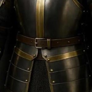May include: Close-up of a medieval-style suit of armor. The armor is primarily black with gold-colored accents and trim. A brown leather belt with a silver buckle is worn around the waist. The armor appears to be made of metal plates.