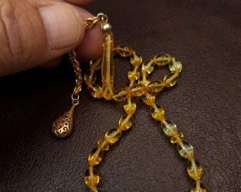 Handmade prayer beads made from transparent amber, with gold-plated silver tassels