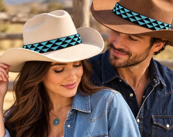May include: Two cowboy hats, one in cream and one in brown, each featuring a decorative band with a geometric pattern of black and bright turquoise blue beads. The hats have a wide brim and a pinched crown, showcasing a classic western style design.