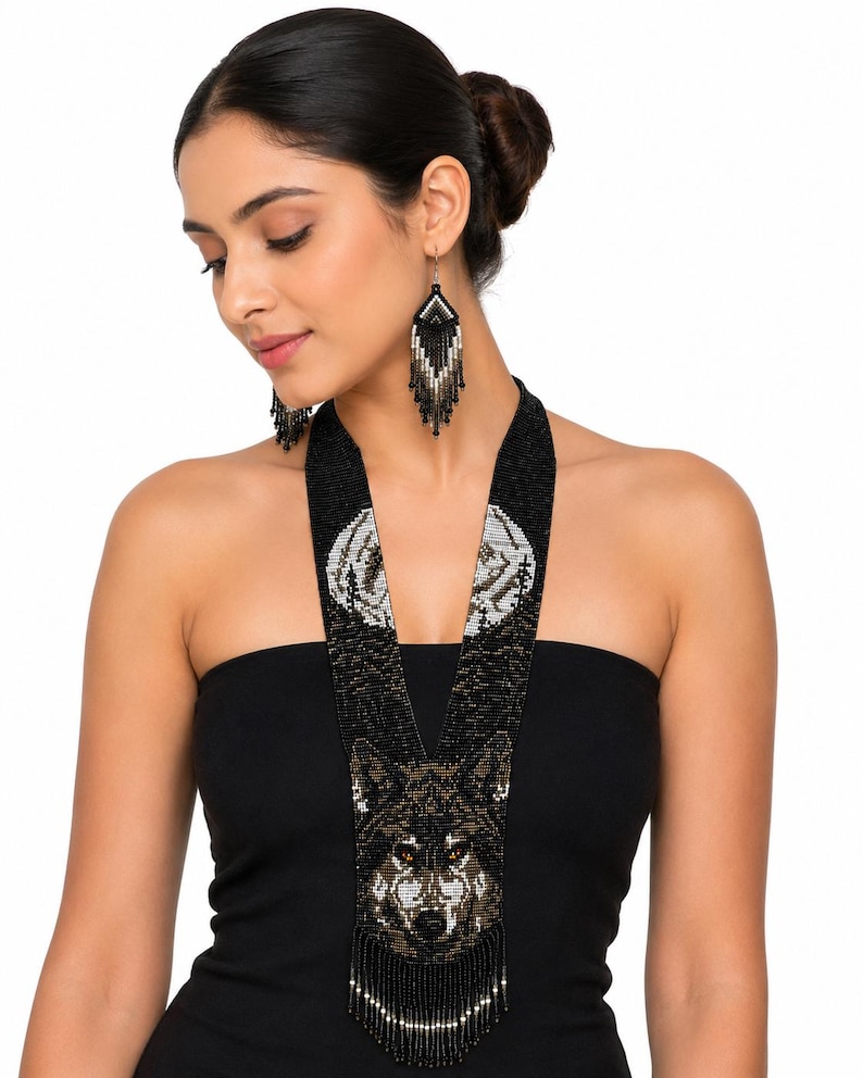 Woman modeling a handcrafted wolf seed bead necklace with coordinating fringe earrings, showcasing artisan beadwork and elegant style.