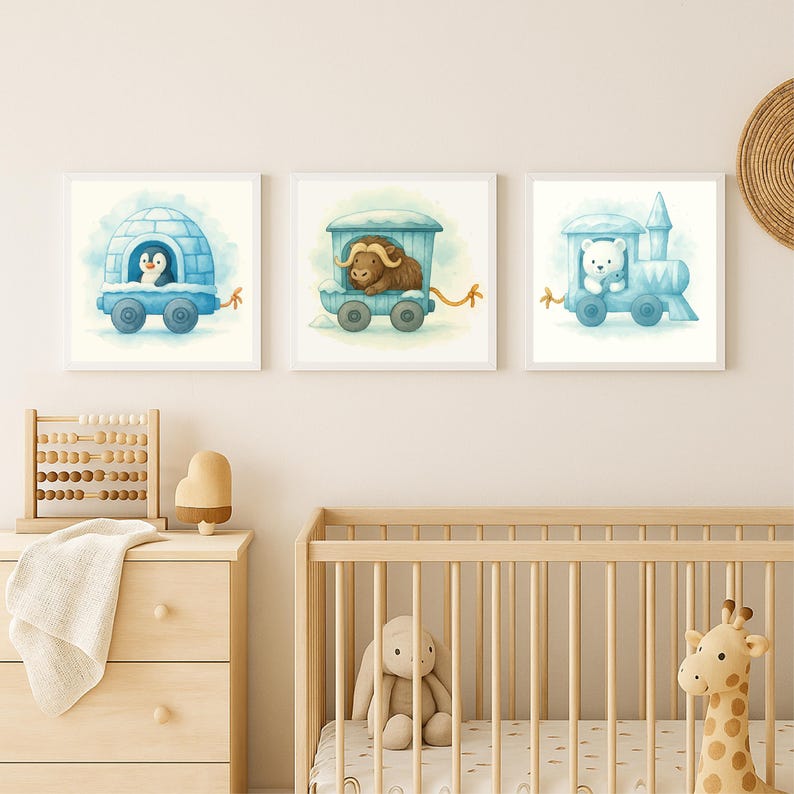 May include: Three framed watercolor prints featuring whimsical illustrations of animals in blue train cars. A penguin in an igloo, a yak, and a polar bear are depicted. The artwork is set against a soft, neutral background, suitable for a nursery or children's room.