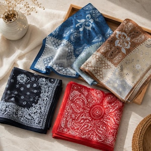 May include: Four square bandanas featuring intricate paisley and floral patterns. One is deep navy with white details, one is bright red with white, one is blue with white, and one is brown with white. Each piece has a distinct border design.