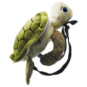 May include: A plush turtle backpack with a green shell, tan body, and blue eyes. The shell has a black geometric pattern. The backpack has a black strap and a zipper closure on the shell. The turtle's flippers are tan.
