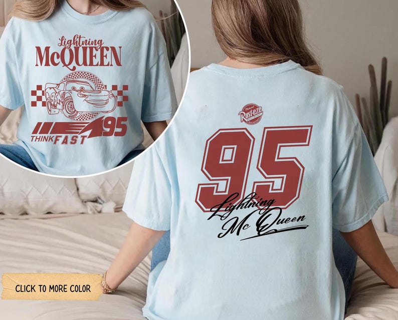May include: Light blue t-shirt featuring Lightning McQueen graphics. The front displays the text "Lightning McQueen" above a car illustration and the number "95". The back of the shirt has a large "95" and "Lightning McQueen" text.