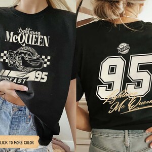 May include: Black t-shirt featuring Lightning McQueen graphic. The front displays the text "Lightning McQueen" above a cartoon car and the number "95". The back of the shirt has a large "95" and "Lightning McQueen" text.