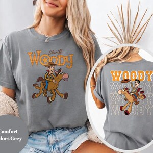 May include: A set of three ceramic mugs with a speckled, matte finish. Each mug features a different color: light blue, cream, and gray. The mugs have a simple, modern design with a rounded shape and a comfortable handle.