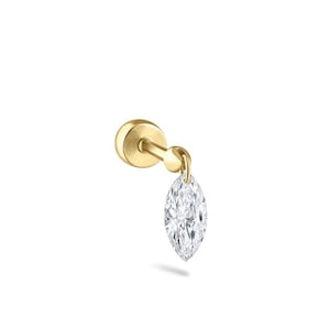 May include: A single gold-colored stud earring with a dangling marquise-cut diamond. The earring has a post and a small, round backing. The diamond is clear and faceted, reflecting light. The earring is set against a white background.
