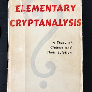 May include: Vintage book titled "Elementary Cryptanalysis" by Helen Fouché Gaines. The cover is off-white with red text and a large gray question mark design. The book's subtitle reads "A Study of Ciphers and Their Solution."