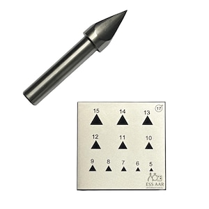 May include: A silver metal tool with a conical point and a cylindrical handle. A rectangular metal plate with black triangle shapes and numbers 5 to 15 is also shown. The plate has the text "ESS AAR INTERNATIONAL".