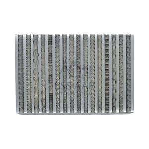 May include: A rectangular metal stamp with various decorative border designs. The stamp features a series of vertical patterns, including floral, geometric, and textured elements. The metal has a silver colour and is set against a white background.