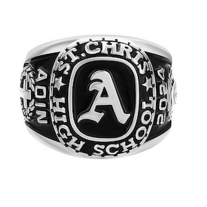 May include: A silver class ring with a black oval centre displaying a white letter "A". The ring is inscribed with "ST. CHRIS HIGH SCHOOL" and "2024". Additional details include "ADIN" and a cross.