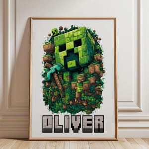 May include: A framed print featuring a green pixelated character with a pickaxe, surrounded by blocks and foliage. The name "OLIVER" is displayed in pixelated letters at the bottom. The artwork has a digital art style.