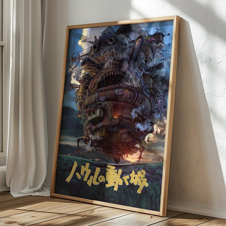 May include: A framed poster featuring a detailed illustration of a fantastical, moving castle with mechanical elements, smoke, and a sunset backdrop. The Japanese title is in gold lettering. The poster is in a wooden frame.