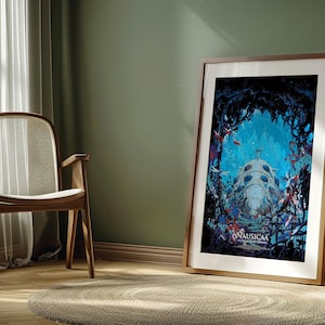 May include: Framed art print featuring a vibrant underwater scene with a large, bioluminescent creature. The artwork, titled "Nausica&auml;", is displayed in a wooden frame, leaning against a green wall. The room includes a wooden chair, a plant, and a round rug.