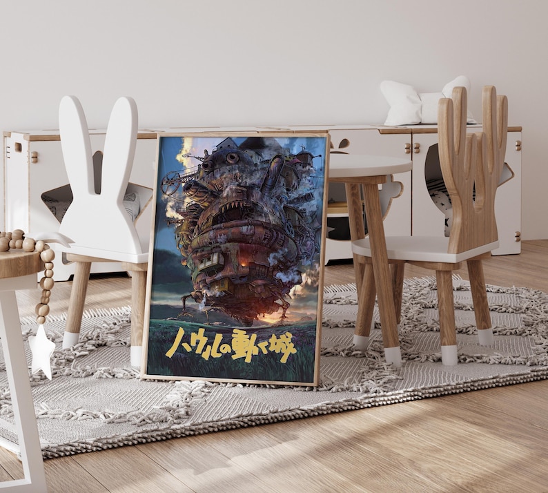 May include: A framed poster featuring a detailed illustration of a fantastical, moving castle with a complex design. The artwork is set against a blue sky and green landscape, with Japanese text at the bottom. The poster is displayed in a child's room.