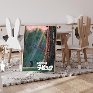 May include: A framed poster featuring Japanese text and artwork from the animated film "Castle in the Sky". The artwork depicts a towering tree, a robot, and a small figure in a forest setting, with light rays shining through the canopy. The poster is displayed in a child's room.