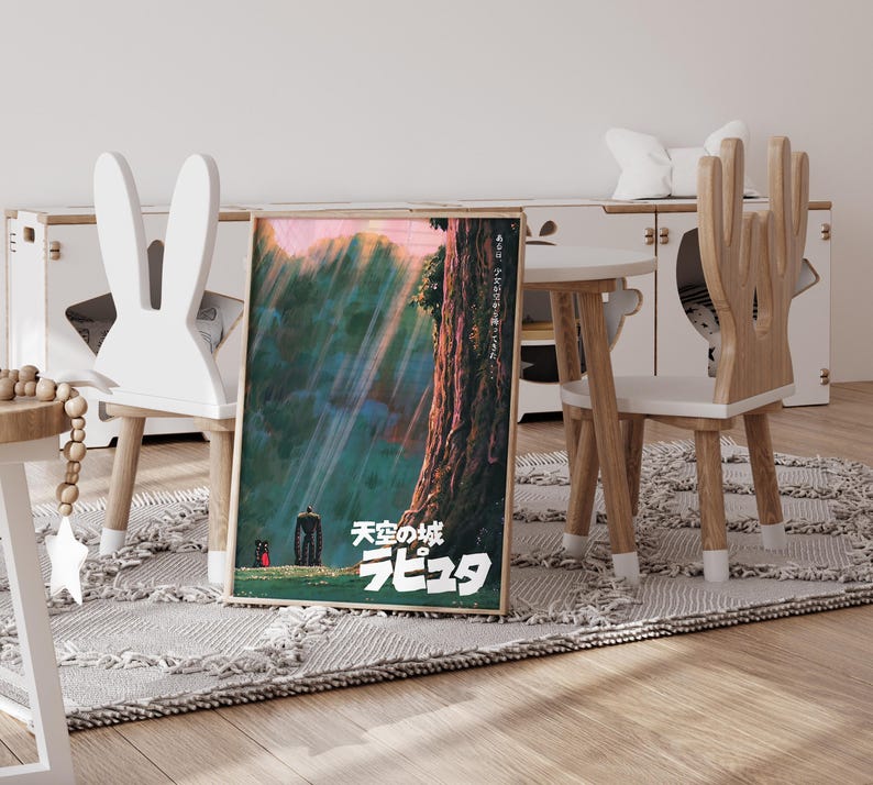 May include: A framed poster featuring Japanese text and artwork from the animated film "Castle in the Sky". The artwork depicts a towering tree, a robot, and a small figure in a forest setting, with light rays shining through the canopy. The poster is displayed in a child's room.