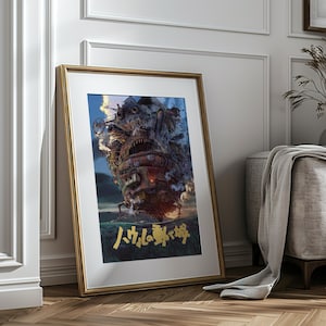 May include: Framed art print featuring a detailed illustration of a moving castle, with a complex design and a fiery, smoky atmosphere. The artwork is set against a blue sky and includes Japanese text in gold. The frame is gold-colored.