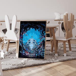 May include: Framed art print featuring a vibrant underwater scene with a large, dome-shaped structure and the text "NAUSICA&Auml;". The artwork is set against a blue background with red and blue accents, creating a fantasy theme.