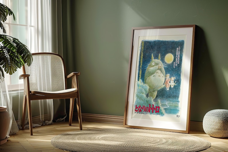 Puede incluir: Un p&oacute;ster enmarcado con una ilustraci&oacute;n caprichosa de una criatura grande, esponjosa y gris con vientre blanco, de pie frente a una luna llena. El p&oacute;ster tiene texto japon&eacute;s y se exhibe en una habitaci&oacute;n con una silla de madera y una alfombra redonda.