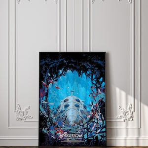 May include: A framed poster featuring a vibrant underwater scene with a large, bioluminescent creature at the center. The artwork showcases a blue and black color palette with red accents, and the title "Nausicaa of the Valley of the Wind" is visible.