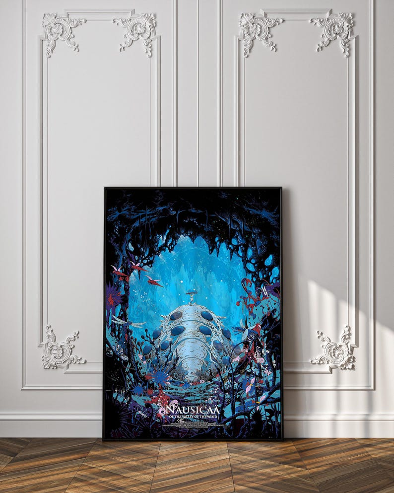 May include: A framed poster featuring a vibrant underwater scene with a large, bioluminescent creature at the center. The artwork showcases a blue and black color palette with red accents, and the title "Nausicaa of the Valley of the Wind" is visible.
