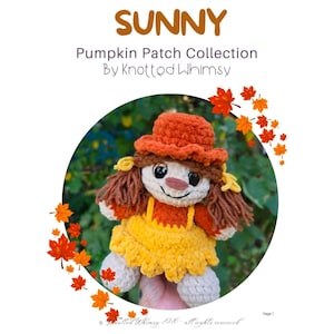 May include: A crochet doll from the Sunny Pumpkin Patch Collection by Knotted Whimsy. The doll features a textured orange hat, brown yarn hair, a cream-colored face with dark eyes, and a yellow dress over a rust-colored top with white feet.