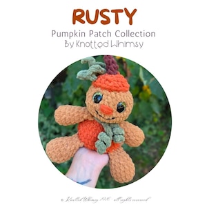 May include: A plush toy named Rusty from the Pumpkin Patch Collection by Knotted Whimsy. The toy is made of tan and orange yarn, featuring a pumpkin-shaped head with a green stem, large dark eyes, and a green scarf around its neck.