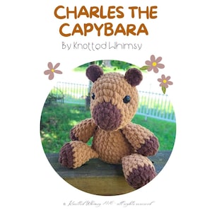 May include: A brown and dark brown crocheted capybara plush toy with black plastic eyes. The text above reads CHARLES THE CAPYBARA By Knotted Whimsy. The toy features a rounded head, small ears, and dark brown accents on the paws and snout area.