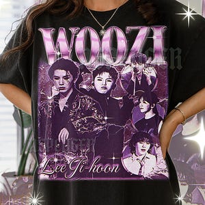 May include: Black t-shirt featuring a purple graphic design with the word "WOOZI" in large, stylized letters. The design includes multiple images of a musical artist, with the name "Lee Ji-hoon" below.