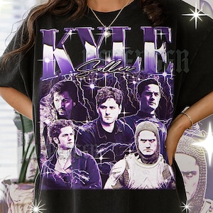 May include: Black t-shirt featuring a graphic design with the name "KYLE" in large purple letters, with the name "Coller" below. The design includes images of several people and lightning bolts.