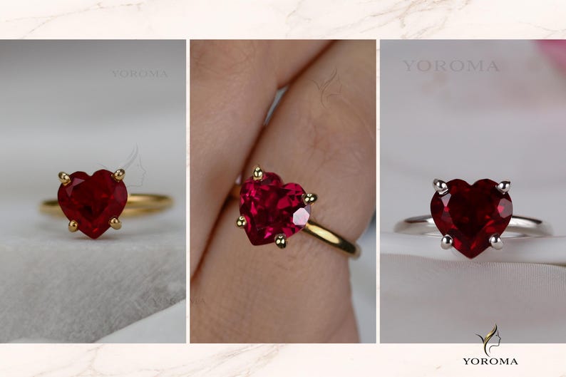 Puede incluir: Un anillo con una piedra preciosa roja en forma de coraz&oacute;n, tallada con facetas y montada en un engaste de cuatro garras. El anillo est&aacute; disponible en bandas de metal dorado y plateado. La marca YOROMA aparece en las esquinas de la imagen.