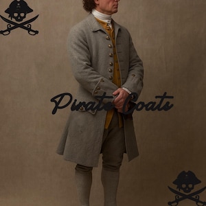 May include: A gray wool coat with gold buttons, part of a historical costume. The coat is knee-length and worn over a yellow vest and breeches. The image includes the text "Pirate Coats" in a script font.