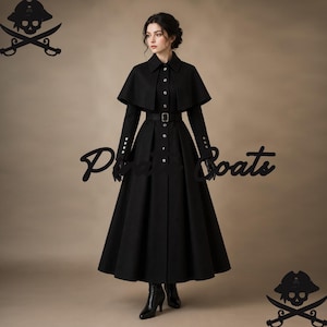May include: A long black coat featuring a capelet overlay, a collared neckline, and a belted waist. The coat has a button-down front with silver-toned buttons, long sleeves with buttoned cuffs, and a full-length skirt. The text Pirate Coats is visible.