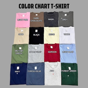 May include: A color chart of t-shirts in various colors, including light pink, dark chocolate, wash, grey, sand, black, beige, white, military green, sport grey, maroon, light blue, navy, corola blue, ash, and forest green. Each shirt has a small button.