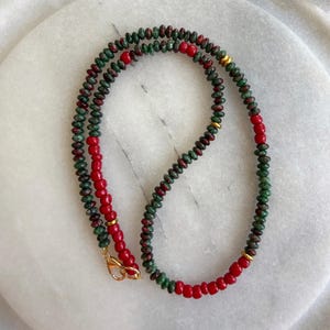 Green stone with red beaded necklace