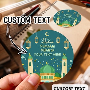 May include: Circular stickers with a teal background and a mosque design, featuring the text "Ramadan Mubarak" and "Custom Text". The stickers have a green dome, beige minarets, and gold lanterns. The image also shows the text "54pcs".