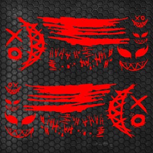 May include: A set of red vinyl decals featuring stylized graphic elements including crescent moon shapes with X and O markings, horizontal brush stroke patterns, repeated HAHA text, and various grinning faces with sharp, pointed teeth.