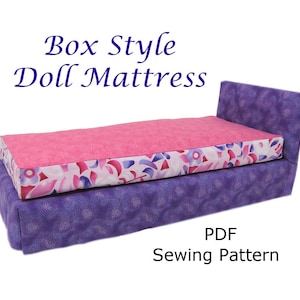 May include: A PDF sewing pattern for a box style doll mattress. The mattress is purple with a pink and white floral print top. The pattern is for a doll mattress.