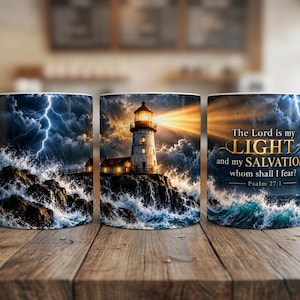 May include: A white ceramic mug featuring a wrap-around graphic of a lighthouse on a rocky shore during a storm with lightning and crashing waves. The text reads: The Lord is my LIGHT and my SALVATION; whom shall I fear? Psalm 27:1.